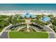 Stunning aerial view of a beachside community center with vibrant landscaping, palm trees and oceanfront access at 118 Ellington Ln., Pawleys Island, SC 29585