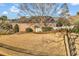 Spacious backyard featuring a lawn with trees and a partial fence line at 118 Ellington Ln., Pawleys Island, SC 29585