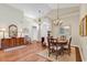 Traditional dining room featuring hardwood floors, a decorative rug, and a chandelier at 118 Ellington Ln., Pawleys Island, SC 29585