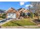 Charming brick home showcasing a well-manicured lawn and an attached two-car garage at 118 Ellington Ln., Pawleys Island, SC 29585