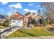 Charming brick home showcasing a well-manicured lawn and an attached two-car garage at 118 Ellington Ln., Pawleys Island, SC 29585