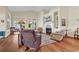 Cozy living room with a fireplace, hardwood floors, and lots of natural light at 118 Ellington Ln., Pawleys Island, SC 29585
