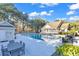 Relaxing community pool area featuring comfortable lounge chairs, shaded tables, and adjacent building for convenience at 118 Ellington Ln., Pawleys Island, SC 29585