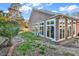 Beautiful sunroom addition on a brick home with large windows and natural light overlooking a lush backyard at 118 Ellington Ln., Pawleys Island, SC 29585