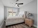 Inviting bedroom featuring a large window, light-colored walls, wood laminate floor and comfortable queen bed at 125 Harbor Oaks Dr., Myrtle Beach, SC 29588