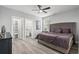 Large bedroom with closet and bathroom entrances, light-colored wood laminate flooring, and neutral colors at 125 Harbor Oaks Dr., Myrtle Beach, SC 29588