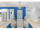 Beautiful dining room boasts a glass table, chandelier lighting, and a statement blue accent wall at 125 Harbor Oaks Dr., Myrtle Beach, SC 29588