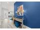 Stylish entryway with blue accent wall, mirrored console table, lamps, and a glimpse into the living space at 125 Harbor Oaks Dr., Myrtle Beach, SC 29588