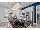 Modern kitchen with black and white backsplash, stainless steel appliances, a dark countertop island, and stylish lighting at 125 Harbor Oaks Dr., Myrtle Beach, SC 29588