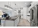 Modern kitchen with stainless steel appliances, granite countertops, sleek white cabinets, and pendant lighting at 125 Harbor Oaks Dr., Myrtle Beach, SC 29588