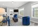 Comfortable living room with a fireplace, large windows offering a view of the outdoors, and modern decor at 125 Harbor Oaks Dr., Myrtle Beach, SC 29588