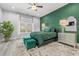 Stylish main bedroom with a lush green accent wall, soft rug and complementary furnishings at 125 Harbor Oaks Dr., Myrtle Beach, SC 29588