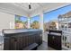 Screened porch with a jacuzzi and outdoor furniture, offering a relaxing view of the surrounding neighborhood at 125 Harbor Oaks Dr., Myrtle Beach, SC 29588