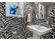Chic powder room features bold zebra wallpaper, pedestal sink, and elegant fixtures at 125 Harbor Oaks Dr., Myrtle Beach, SC 29588