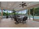 Enclosed sunroom with multiple tables and chairs overlooking the pool and waterfront at 125 Harbor Oaks Dr., Myrtle Beach, SC 29588