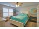 Bright bedroom featuring a ceiling fan, bright windows, and a comfortable queen sized bed at 127 Clover Walk Dr., Conway, SC 29526