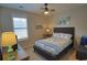 Cozy bedroom featuring coastal decor, a ceiling fan, and a large window for natural light at 127 Clover Walk Dr., Conway, SC 29526