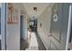 Inviting hallway with hardwood floors and neutral walls, illuminated by natural light and modern light fixtures at 127 Clover Walk Dr., Conway, SC 29526