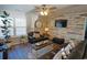 Inviting living room featuring a wood accent wall, comfortable seating, and a ceiling fan at 127 Clover Walk Dr., Conway, SC 29526