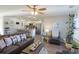 Open concept living room and kitchen with hardwood floors, modern furnishings, and natural light at 127 Clover Walk Dr., Conway, SC 29526