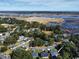 Wide aerial shot showcasing a neighborhood near marshland, under a blue sky, some homes featuring solar panels at 13 Daniel Morrall Ln., Georgetown, SC 29440