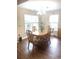 Cozy dining area showcasing wood floors, a chandelier, and natural light from the windows at 13 Daniel Morrall Ln., Georgetown, SC 29440