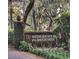 The Wedgefield Plantation entrance sign is surrounded by lush greenery and Spanish moss at 13 Daniel Morrall Ln., Georgetown, SC 29440