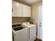 Convenient laundry room features modern washer and dryer units and ample cabinet space at 13 Daniel Morrall Ln., Georgetown, SC 29440
