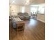 Open-concept living space featuring wood flooring, a cozy seating area, and dining room at 13 Daniel Morrall Ln., Georgetown, SC 29440