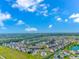 Aerial view of a residential neighborhood with swimming pool, ponds, and wooded area at 135 Butkus Dr. # 5, Myrtle Beach, SC 29588