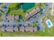 Aerial view of homes, parking, a pond, and a pool with clear blue water on a bright day at 135 Butkus Dr. # 5, Myrtle Beach, SC 29588