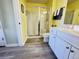 Well-lit bathroom with a glass-enclosed shower, white vanity, and coordinated accessories for a spa-like feel at 135 Butkus Dr. # 5, Myrtle Beach, SC 29588