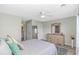 Bright bedroom with soft green walls, ceiling fan, and dresser; bathroom is on the left of the image at 135 Butkus Dr. # 5, Myrtle Beach, SC 29588