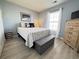 Comfortable bedroom with a cozy bed, wood floors, window with curtains and accent furniture and decor at 135 Butkus Dr. # 5, Myrtle Beach, SC 29588