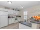 Bright kitchen with white cabinets, modern appliances, and updated countertops with a double sink at 135 Butkus Dr. # 5, Myrtle Beach, SC 29588