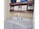 Laundry room with washer, dryer, and rustic shelves and decorations at 135 Butkus Dr. # 5, Myrtle Beach, SC 29588