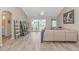 Bright living room with vaulted ceilings, wood floors, and sliding glass doors to the patio at 135 Butkus Dr. # 5, Myrtle Beach, SC 29588