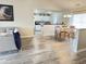Open living area with wood floors, leading to a dining area and kitchen with white cabinets at 135 Butkus Dr. # 5, Myrtle Beach, SC 29588