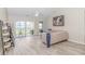 Bright living room with vaulted ceiling, wood floors, and a sliding glass door to the patio at 135 Butkus Dr. # 5, Myrtle Beach, SC 29588