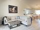 Comfortable living room with wood floors, a sectional sofa, and views into the dining room and kitchen at 135 Butkus Dr. # 5, Myrtle Beach, SC 29588