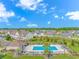 Community pool surrounded by lush landscaping and seating on a bright, sunny day with clear blue skies at 135 Butkus Dr. # 5, Myrtle Beach, SC 29588