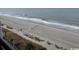 Expansive view of the sandy beach, gentle waves, and horizon from a high vantage point at 1501 S Ocean Blvd. # 935, Myrtle Beach, SC 29577