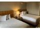 Inviting bedroom featuring two beds, a nightstand with lamp, and a neutral color palette at 1501 S Ocean Blvd. # 935, Myrtle Beach, SC 29577