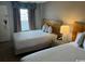 Comfortable hotel room with two beds, lamp on nightstand, and large window with bright curtains at 1501 S Ocean Blvd. # 935, Myrtle Beach, SC 29577