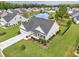 Beautiful aerial view of this home showcasing the lush landscaping and pond in the community at 172 Board Landing Circle, Conway, SC 29526