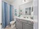 Bathroom featuring gray vanity, a shower with a striped curtain, and neutral tile flooring at 172 Board Landing Circle, Conway, SC 29526