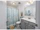 Well-lit bathroom with a vanity, framed mirror, and a shower/tub combination with a themed shower curtain at 172 Board Landing Circle, Conway, SC 29526