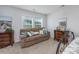 Comfortable bedroom featuring a plush couch, complemented by two wooden end tables, and soft carpeting at 172 Board Landing Circle, Conway, SC 29526