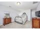 Cozy bedroom with a decorative wrought iron bed frame, complementary furniture, and soft carpeting at 172 Board Landing Circle, Conway, SC 29526
