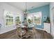 Charming dining room featuring a wood table set for four under a chandelier with large windows at 172 Board Landing Circle, Conway, SC 29526